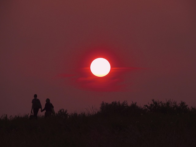Two kayakers navigating a serene salt marsh at Pawleys Island at sunset