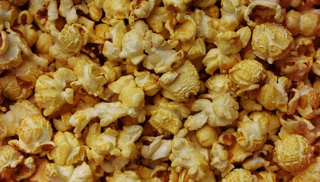 Moviegoers enjoying gourmet snacks and cocktails in a luxury cinema setting